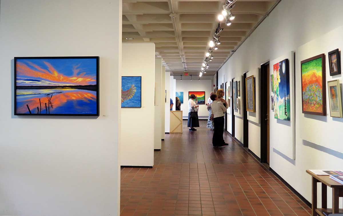 View of the Higgins Education Wing 1st floor walkway with adult student artwork on display